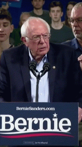 Man speaking at a Bernie Sanders rally, followed by a map of Colorado and New Mexico.