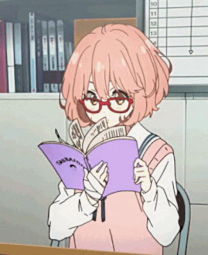 Person with pink hair and glasses reading a purple book at a desk in a library.