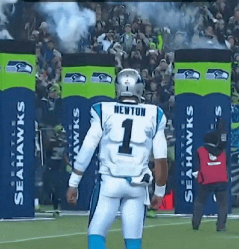 Football player Newton walking and turning to look back.
