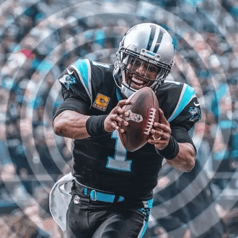 Football player holding a ball, preparing to throw.
