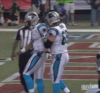 Football player fumbles ball, walks away as teammates and officials react.
