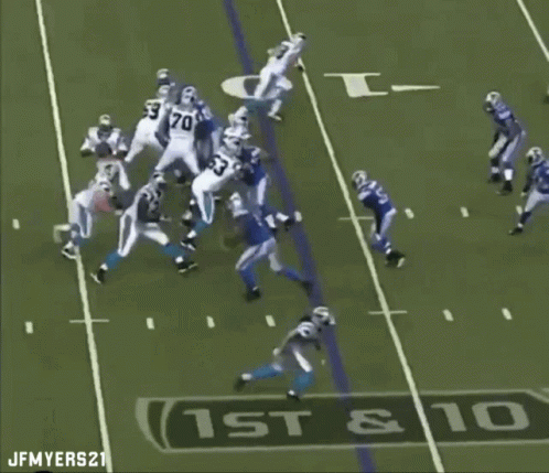 Football quarterback fumbles the ball after being hit during a play.