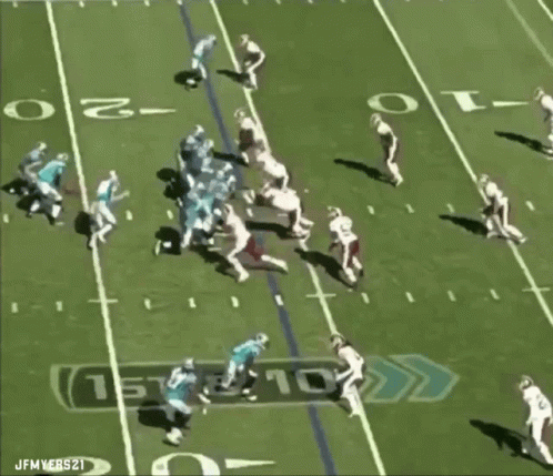 Football player fumbles ball during tackle, opponent recovers.