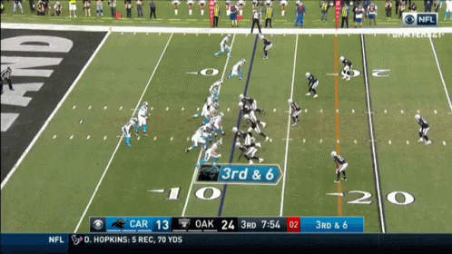 Football player fumbles the ball during a play, teammate recovers.