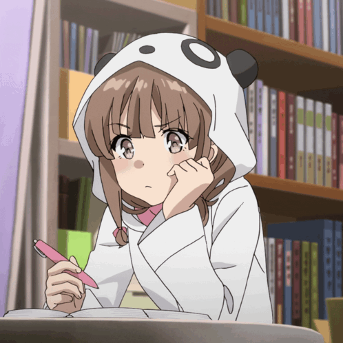 Girl in panda hoodie studying at desk with pen