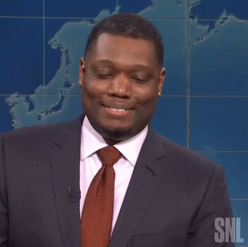 Laughing Michael Che GIF