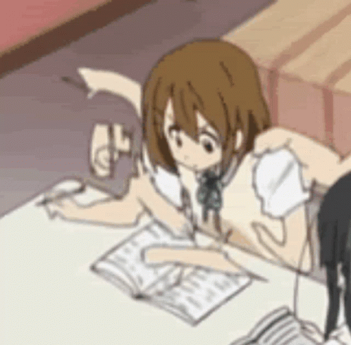 Anime girl writing in notebook at desk