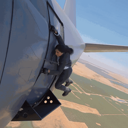 Hanging On The Side Of A Plane Michelle Khare GIF