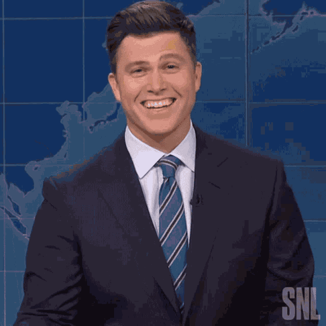 Laughing Colin Jost GIF