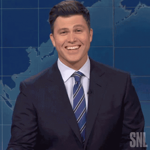 Laughing Colin Jost GIF