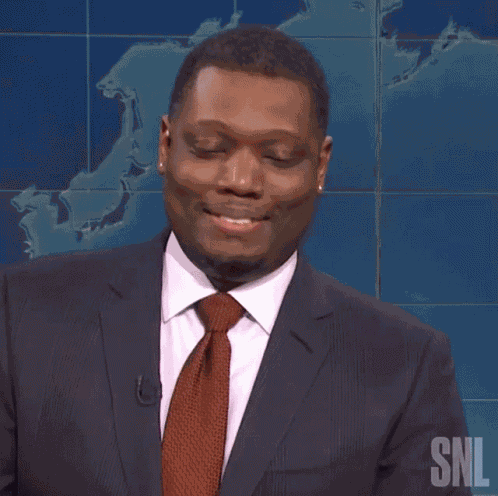 Laughing Michael Che GIF