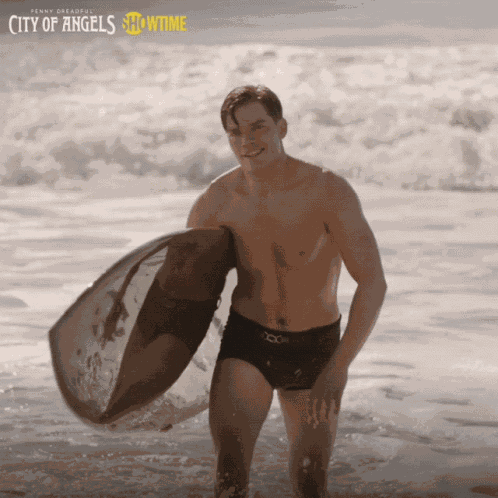 Smiling Dominic Sherwood GIF